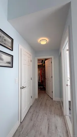 a view of hallway with wooden floor