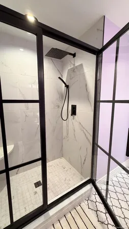 a bathroom with a shower and a window