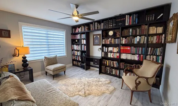 a living room with furniture and a book shelf