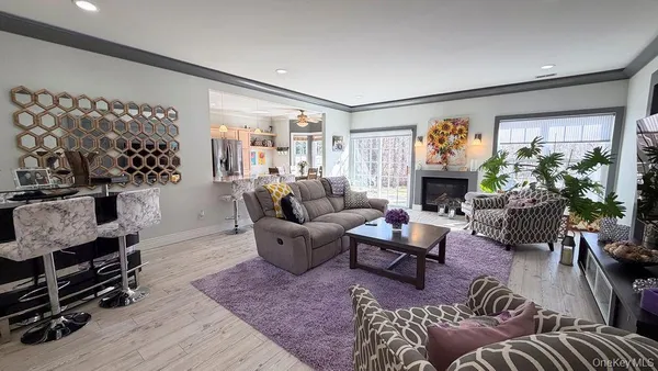 a living room with furniture a fireplace and a window
