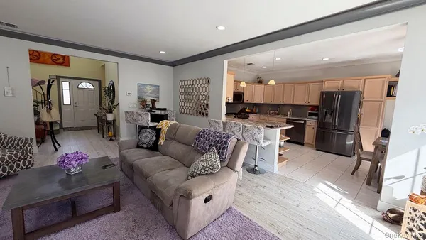 a living room with furniture and kitchen view