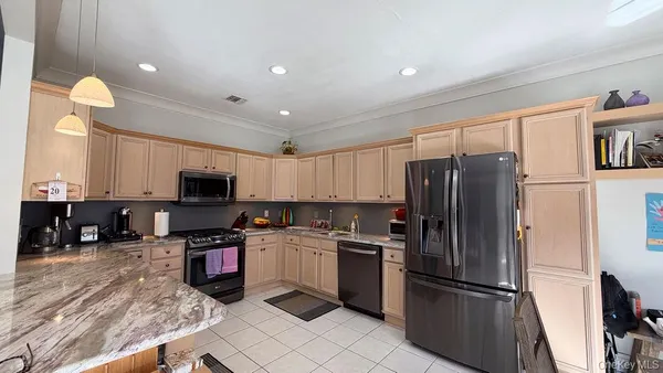a kitchen with a refrigerator a microwave a sink and a stove