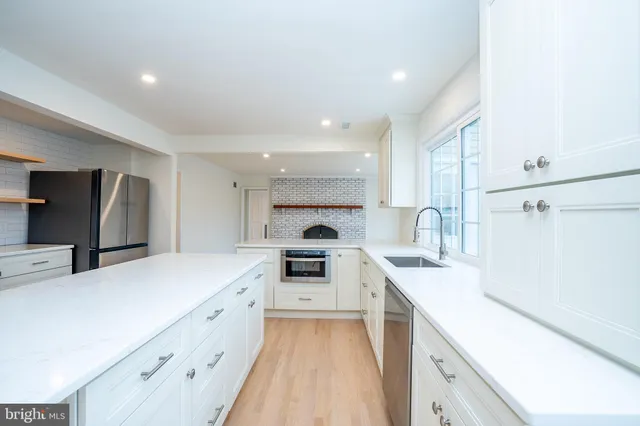 a bathroom with a granite countertop sink vanity and mirror