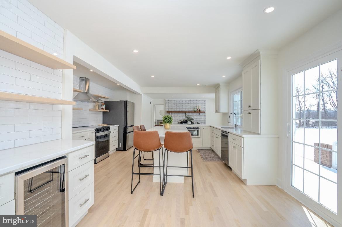 150 Windsor Road Robbinsville, NJ 08691 - Photo 19 of 60 a kitchen with stainless steel appliances kitchen island granite countertop a stove a sink and a refrigerator