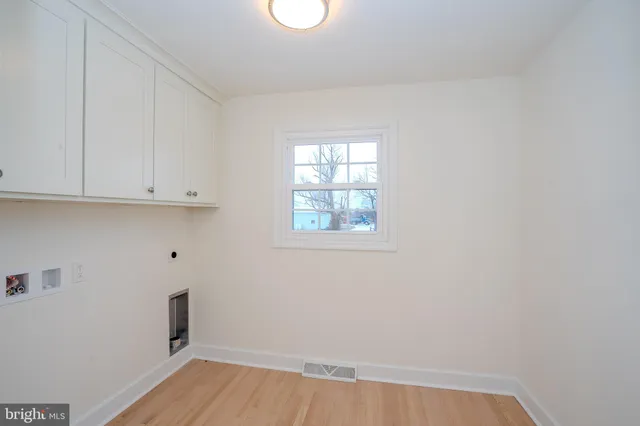a view of wooden floor and windows in a room