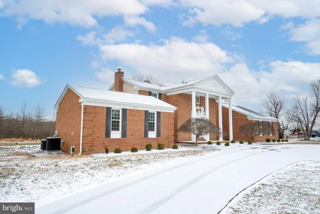 a view of a house with snow on the road