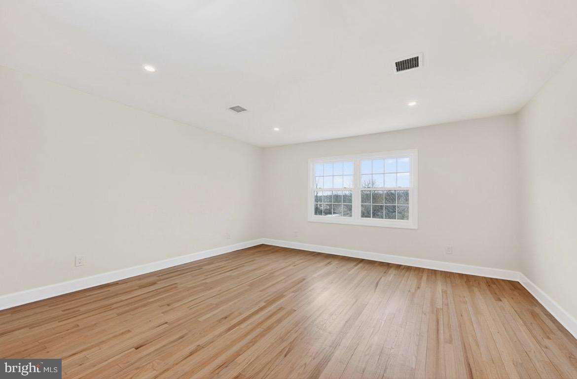 150 Windsor Road Robbinsville, NJ 08691 - Photo 32 of 60 a view of an empty room with wooden floor and a window