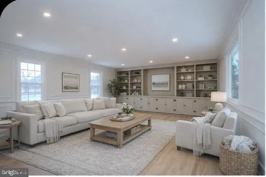 a living room with a fireplace and wooden floor