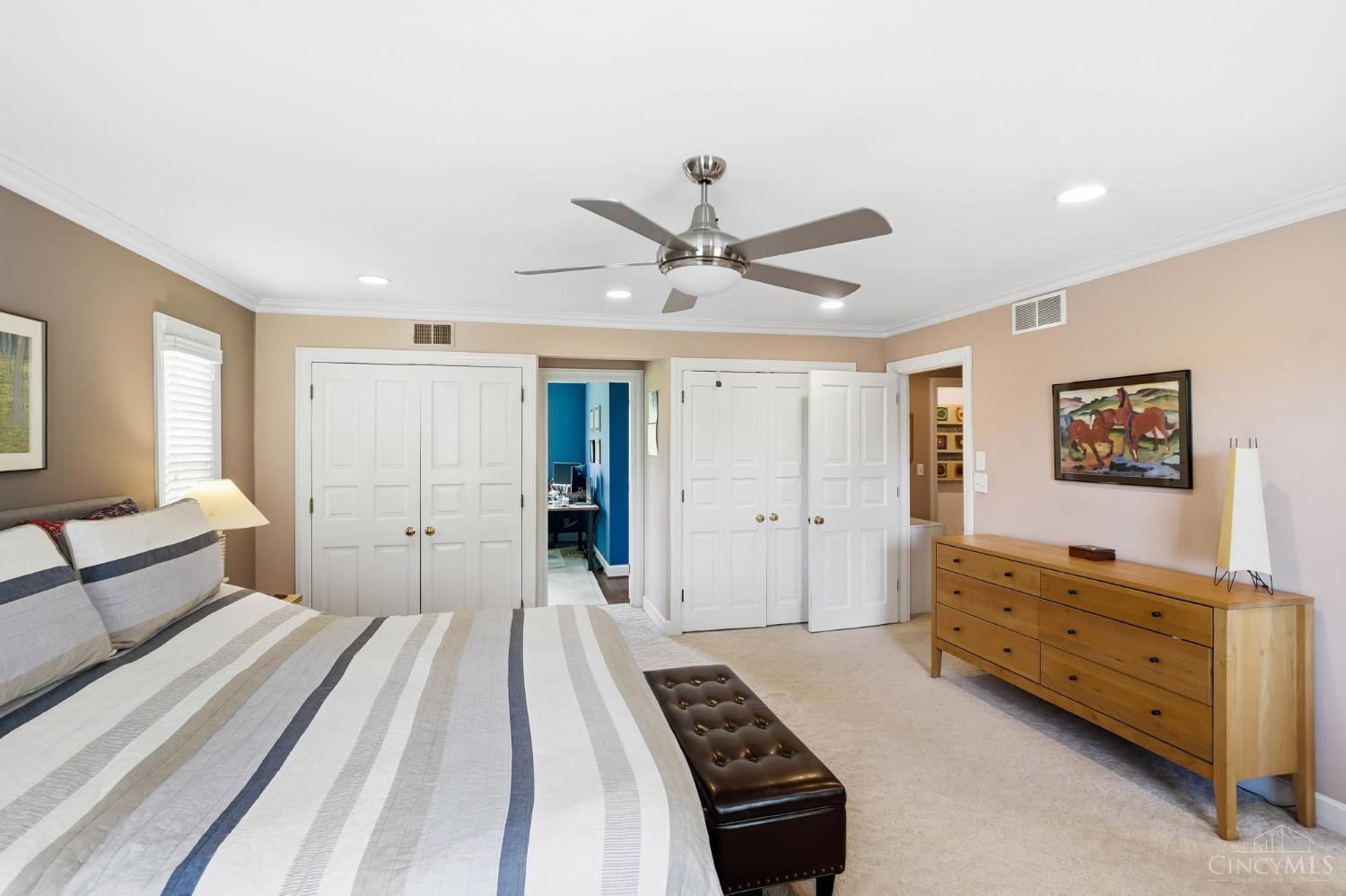 2780 Walsh Road Cincinnati, OH 45208 - Photo 27 of 68 The spacious primary suite serves as a true retreat, offering generous proportions, soft natural light, and a calming, neutral palette. The bedroom easily accommodates full furnishings with room to spare, creating an inviting and restful atmosphere. An adjoining sitting room provides the perfect flex space for a home office, reading nook, or private lounge, while the expansive walk-in closet delivers exceptional storage and organization. The suite is further complemented by an ensuite bath, completing this comfortable and well-appointed primary sanctuary.