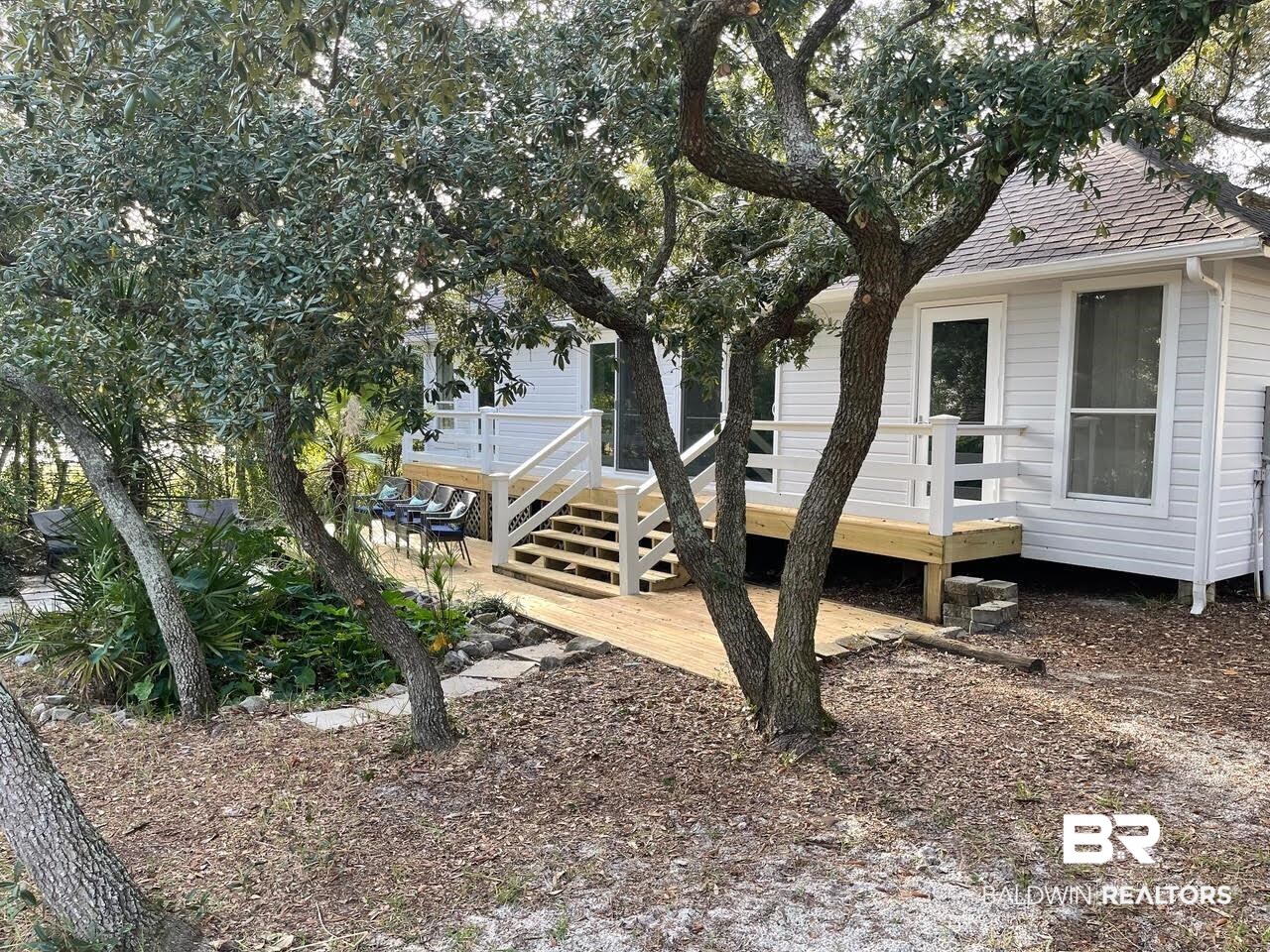 413 West Fort Morgan Road Gulf Shores, AL 36542 - Photo 26 of 29 Exterior space featuring a shingled roof and a wooden deck