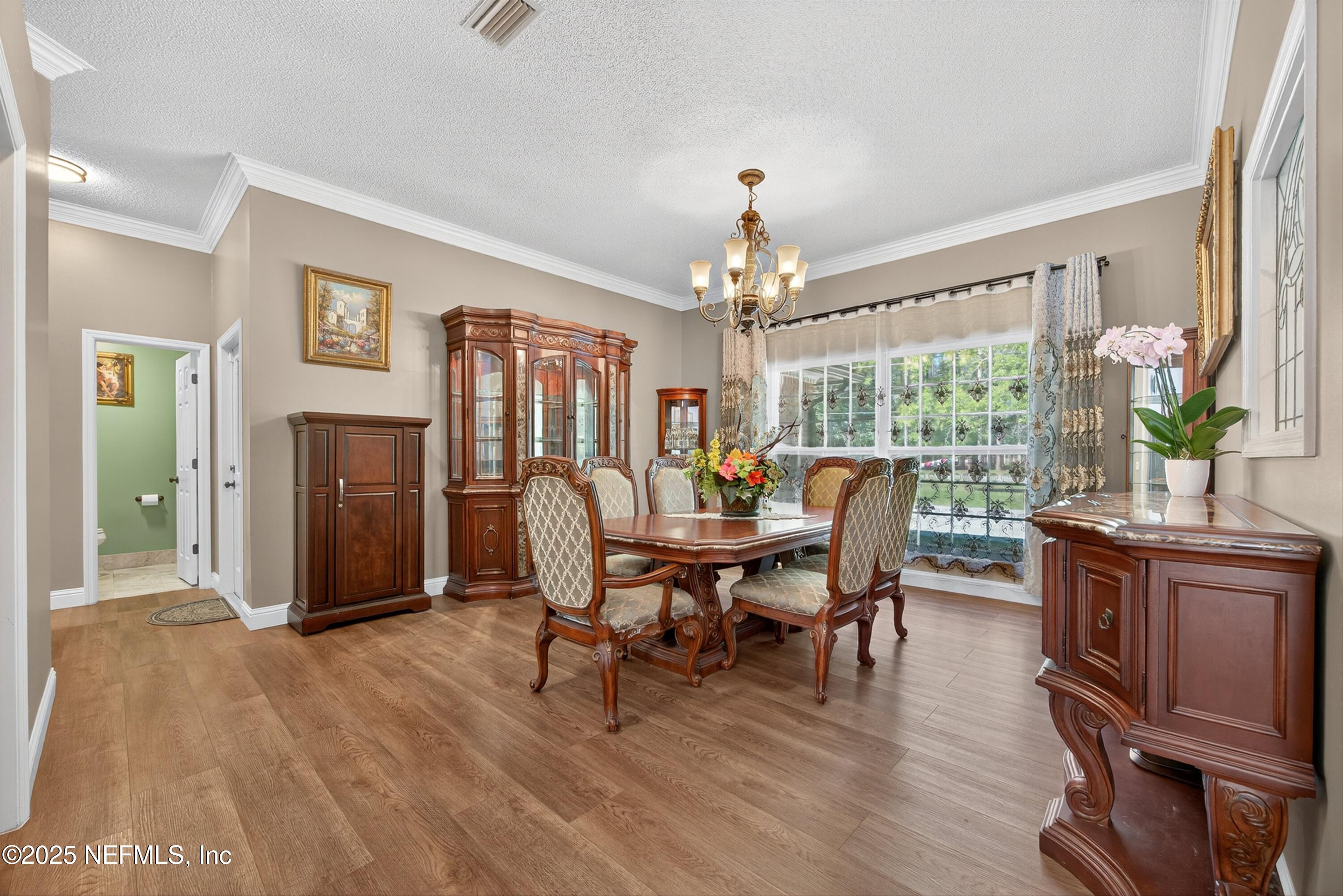 11341 V C Johnson Road Jacksonville, FL 32218 - Photo 11 of 70 a view of a dining room with furniture window and wooden floor