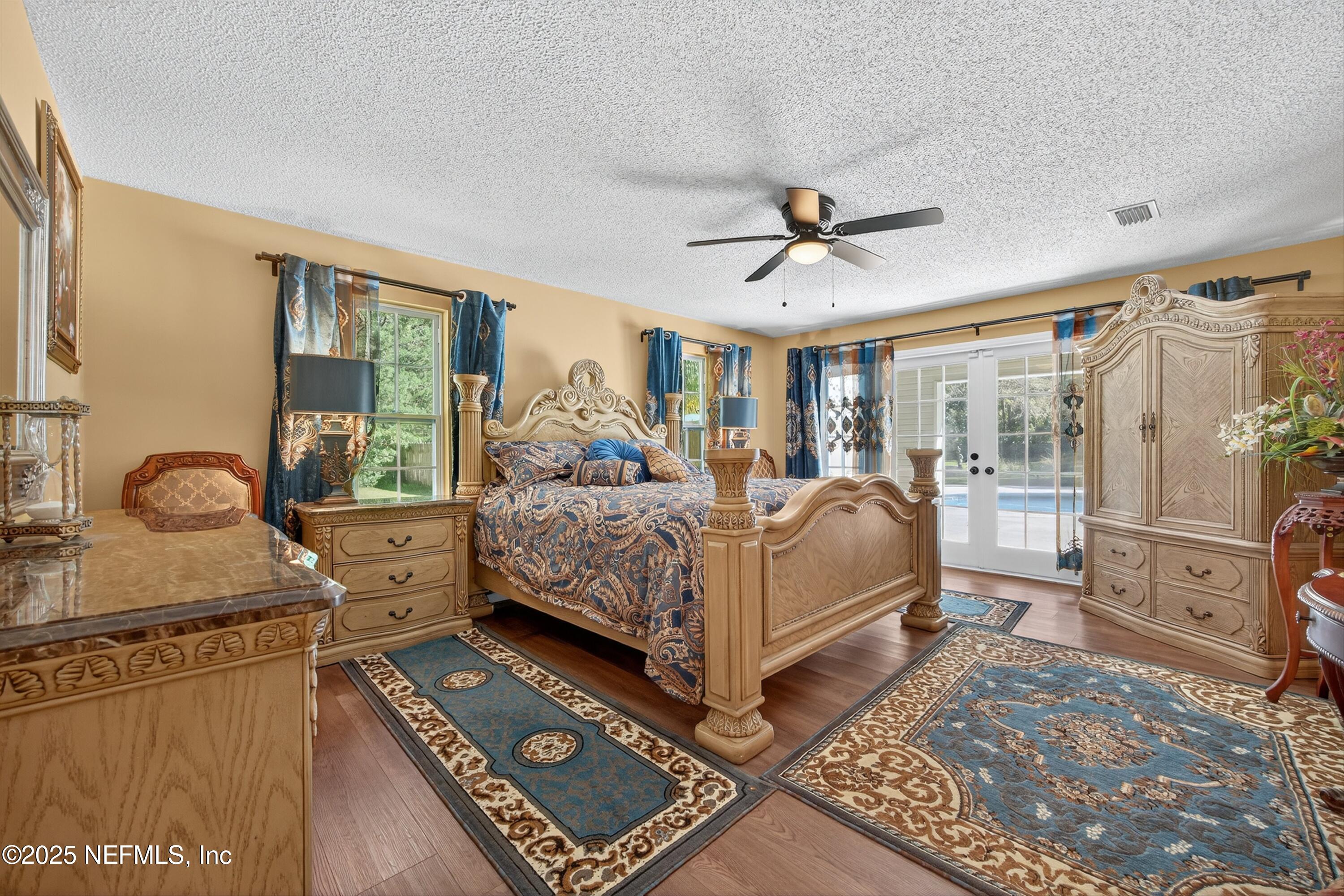 11341 V C Johnson Road Jacksonville, FL 32218 - Photo 19 of 70 a bedroom with a bed dresser and a large window