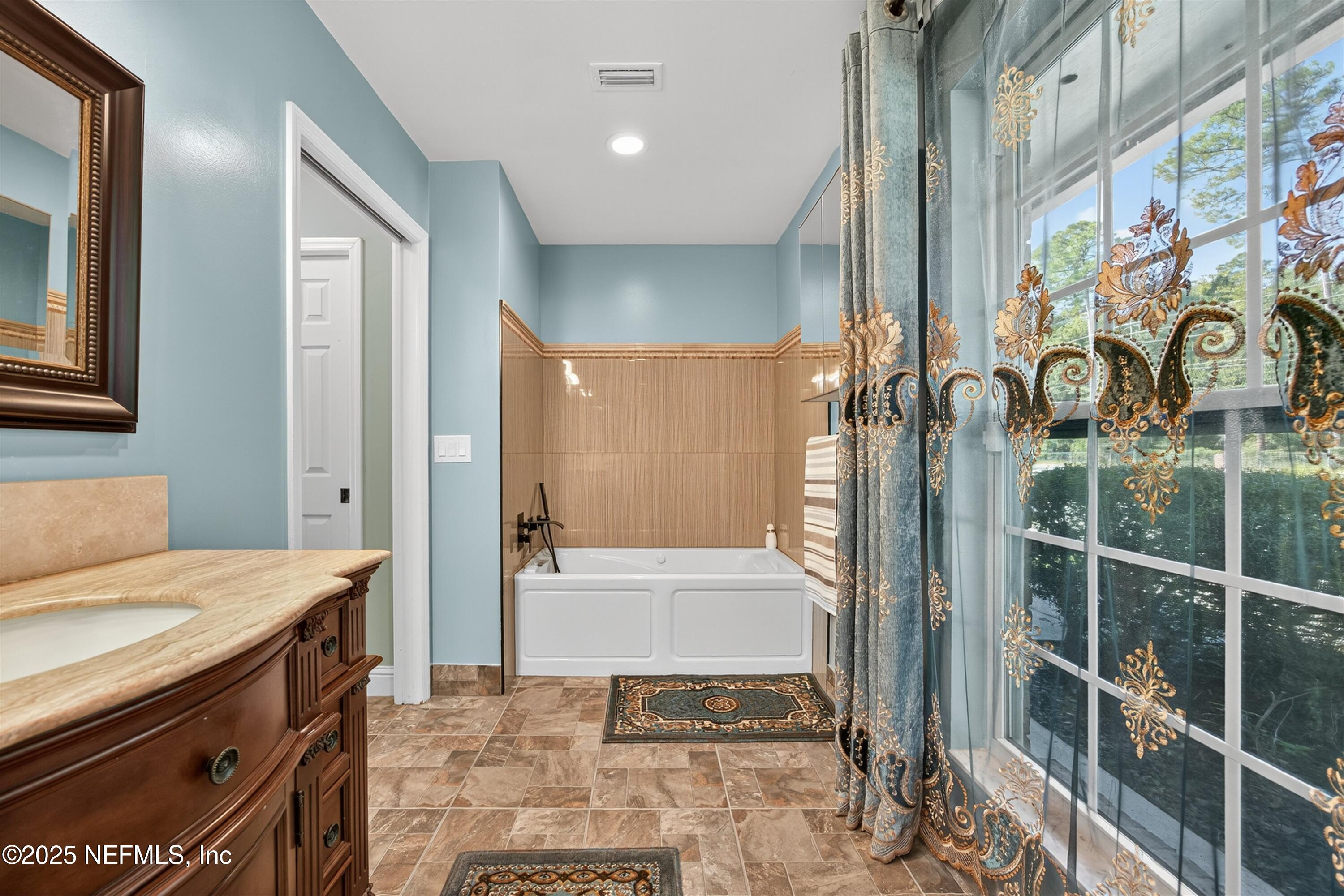 11341 V C Johnson Road Jacksonville, FL 32218 - Photo 23 of 70 a bathroom with a bathtub and a shower