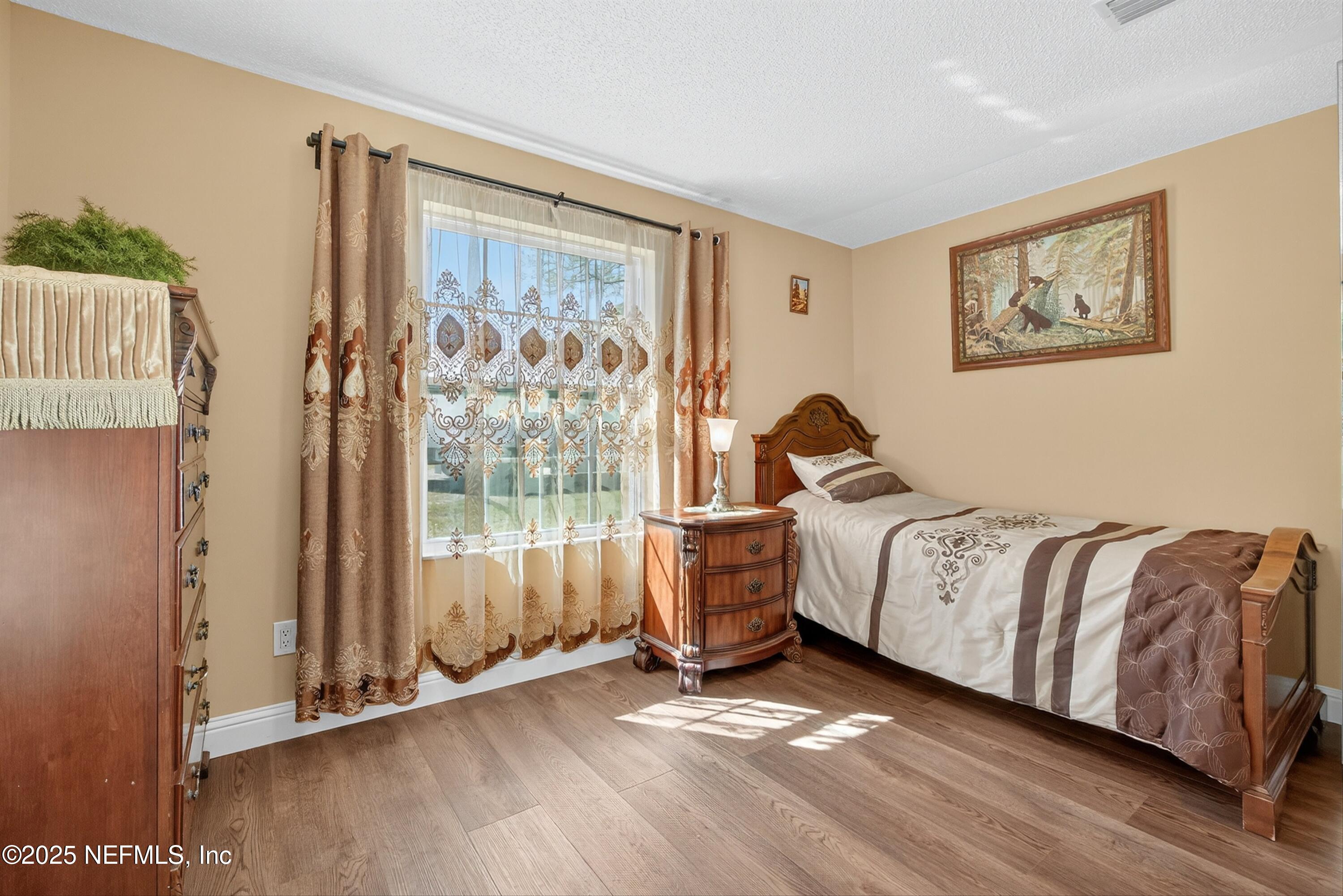 11341 V C Johnson Road Jacksonville, FL 32218 - Photo 28 of 70 a bedroom with a bed and a window