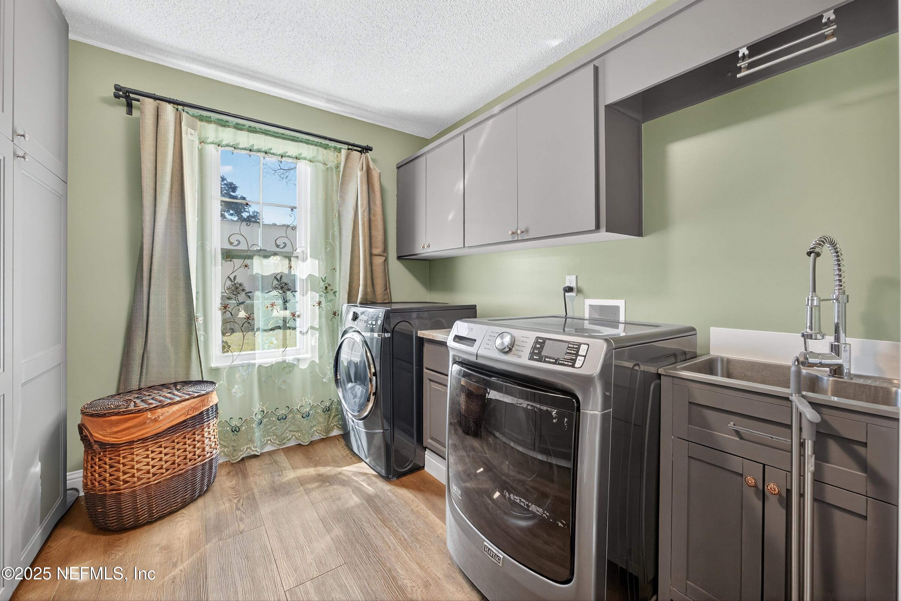 11341 V C Johnson Road Jacksonville, FL 32218 - Photo 32 of 70 a utility room with cabinets washer and dryer