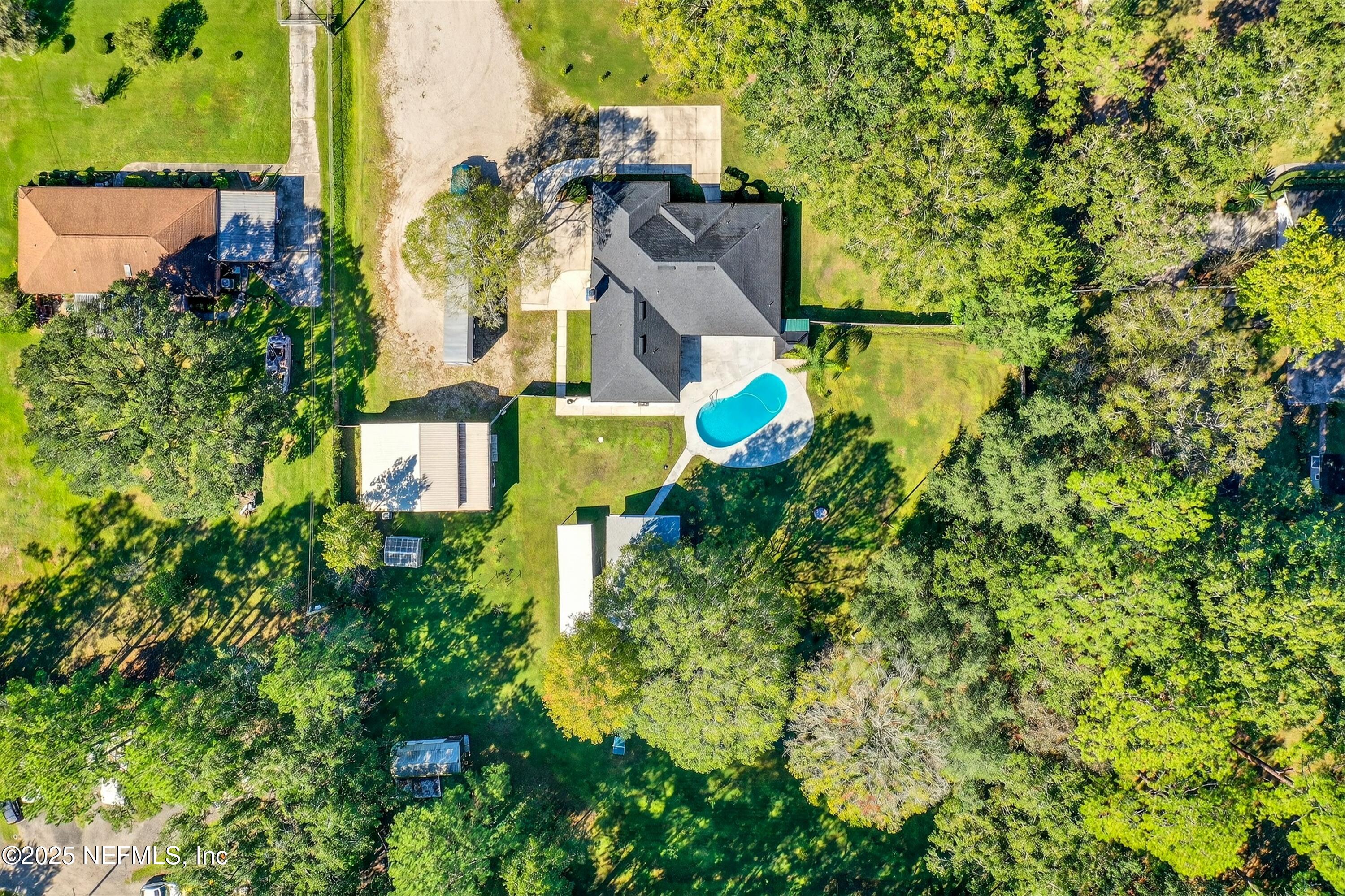 11341 V C Johnson Road Jacksonville, FL 32218 - Photo 36 of 70 an aerial view of a house with swimming pool and garden