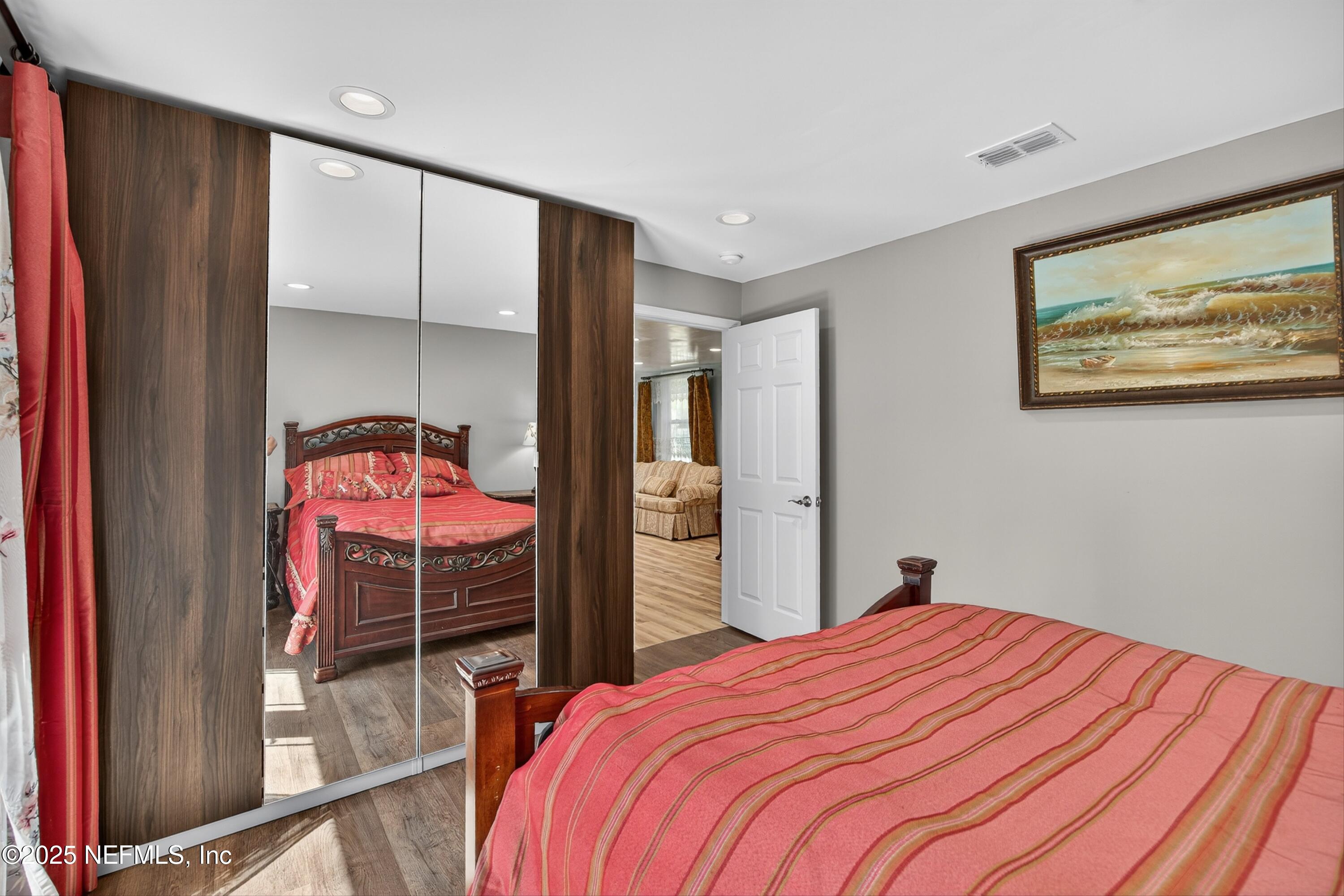 11341 V C Johnson Road Jacksonville, FL 32218 - Photo 51 of 70 a bedroom with a bed and a mirror