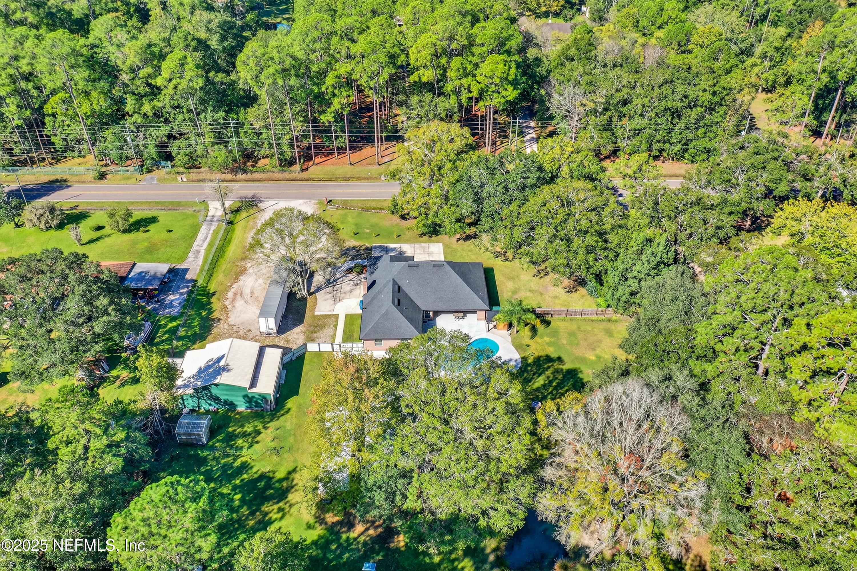 11341 V C Johnson Road Jacksonville, FL 32218 - Photo 61 of 70 an aerial view of residential house with outdoor space and trees all around