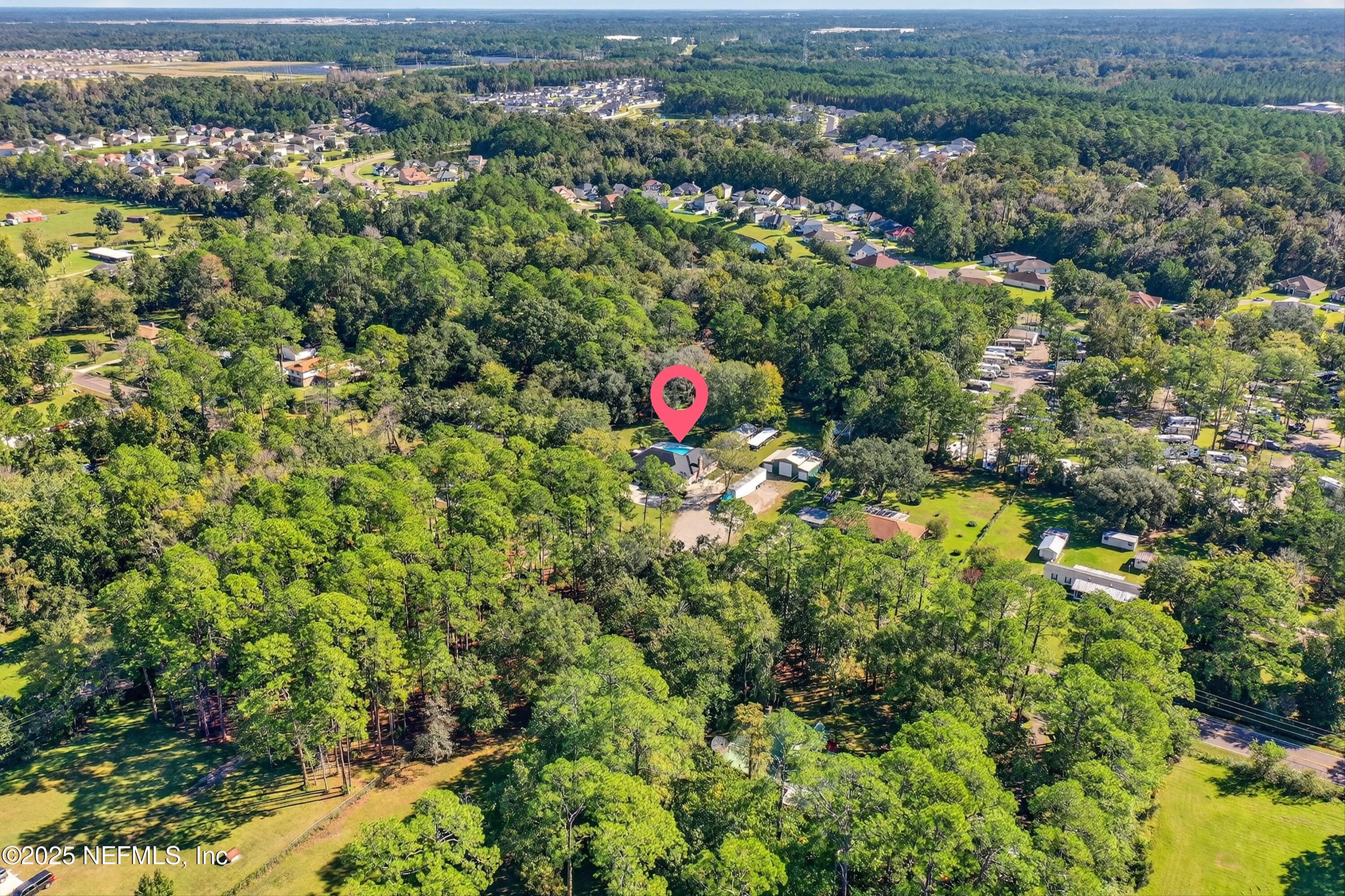 11341 V C Johnson Road Jacksonville, FL 32218 - Photo 66 of 70 an aerial view of a houses with a lush green hillside