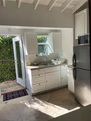 a kitchen with a refrigerator and a sink
