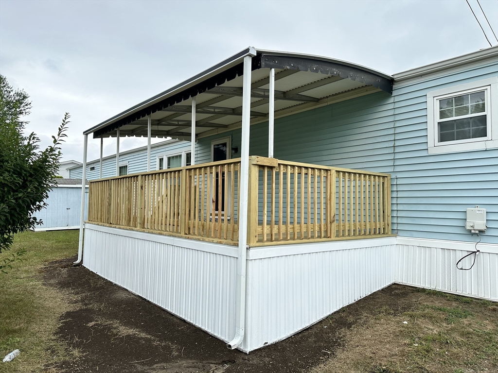 4 Tucker Terrace Raynham, MA 02767 - Photo 29 of 29 a view of a house with a wooden deck