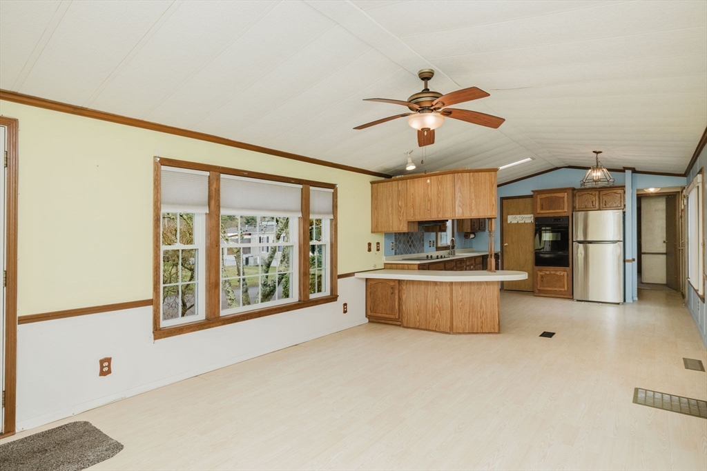 4 Tucker Terrace Raynham, MA 02767 - Photo 4 of 29 a large kitchen with a large window stainless steel appliances and cabinets