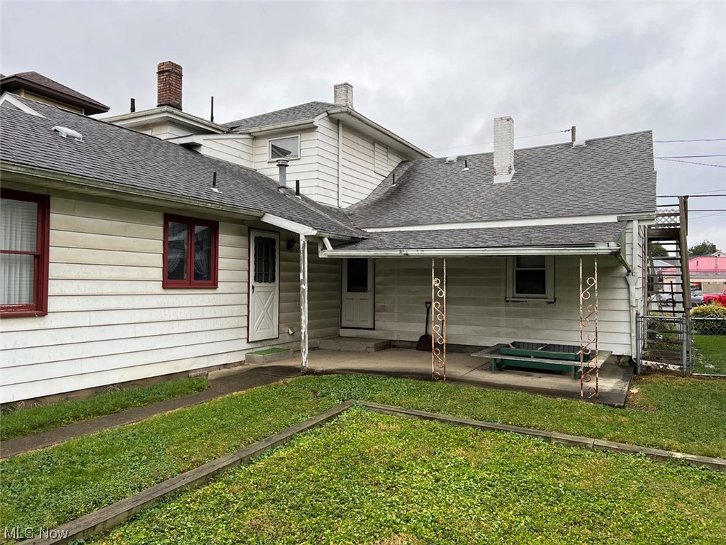 918 Amherst Road Northeast Massillon, OH 44646 - Photo 7 of 31 Rear view of house featuring a lawn and a patio