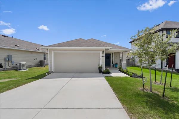 a front view of house with yard and green space