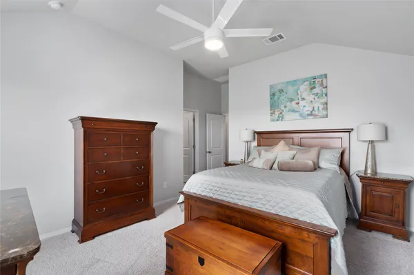 a bedroom with a bed and a television