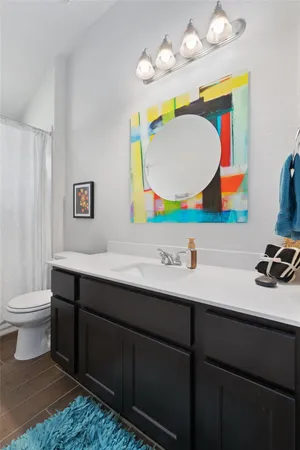 a bathroom with a sink mirror toilet and bathtub