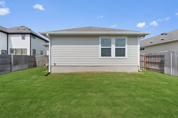 a view of a house with a backyard
