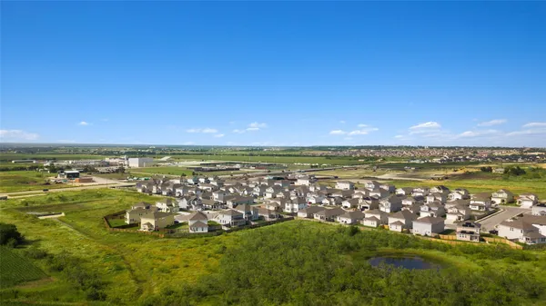 a view of a lake with houses in the background