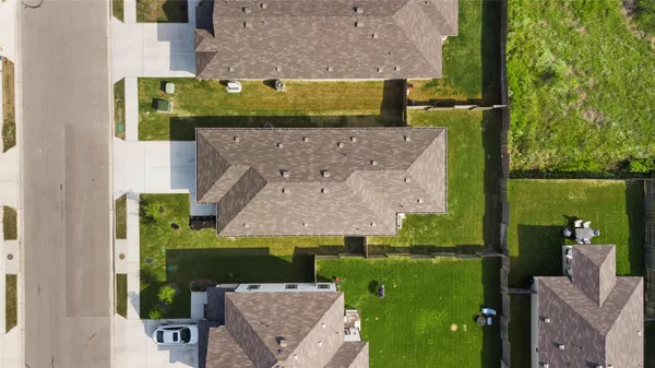 an aerial view of a house with a yard