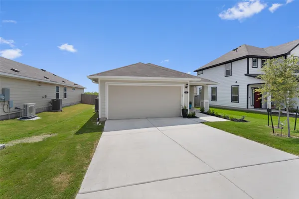 a front view of house with yard and green space