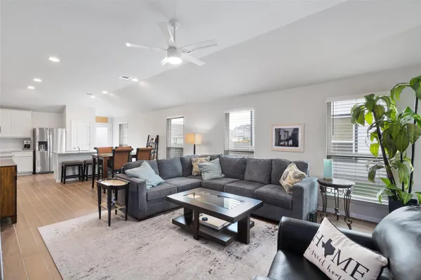 a living room with furniture potted plant and a window