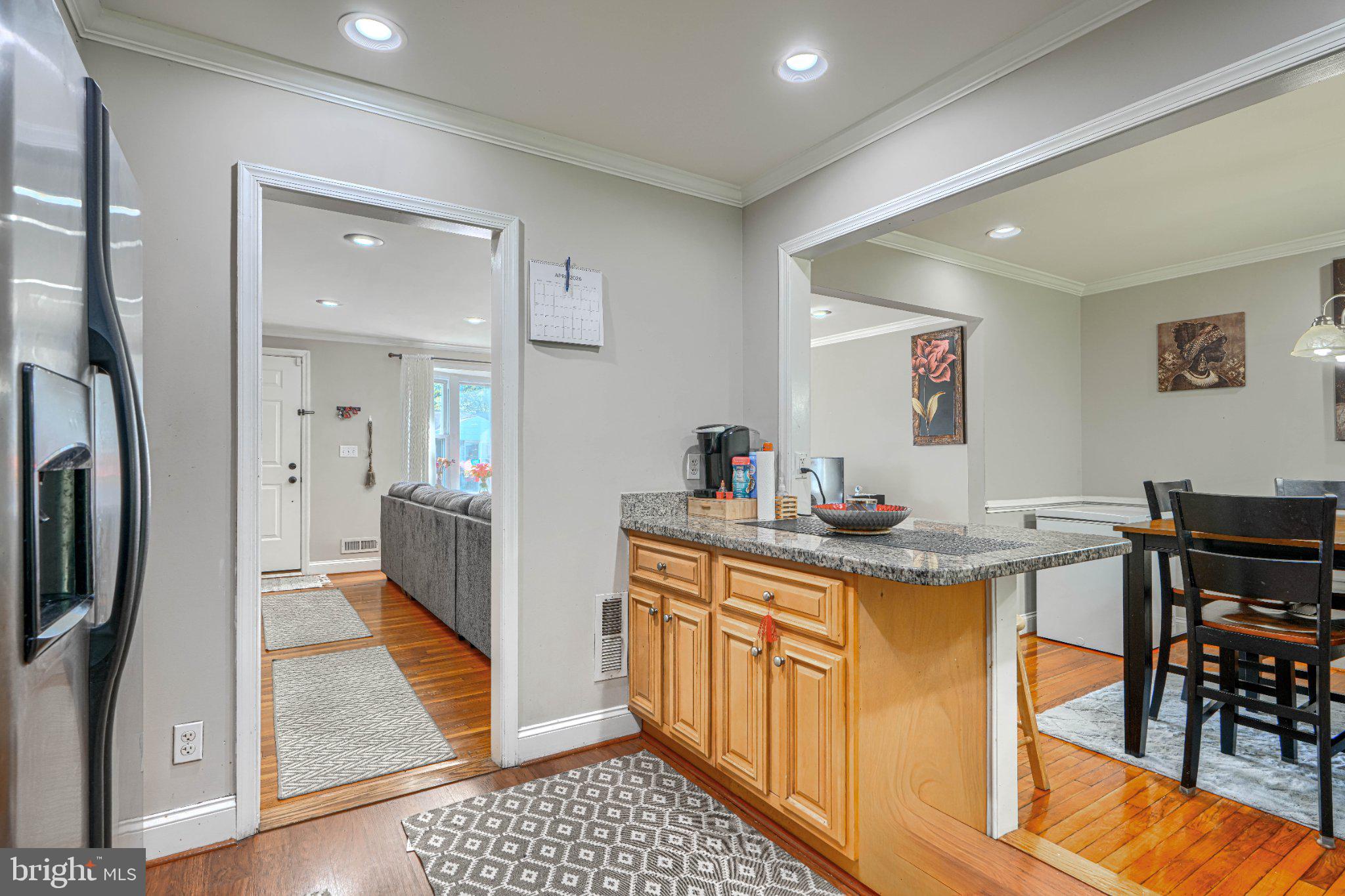 3708 Cassen Road Randallstown, MD 21133 - Photo 12 of 38 a view of a kitchen area with furniture and wooden floor