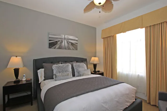 a bedroom with a bed and a painting