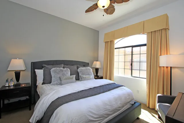 a bedroom with a bed and a lamp