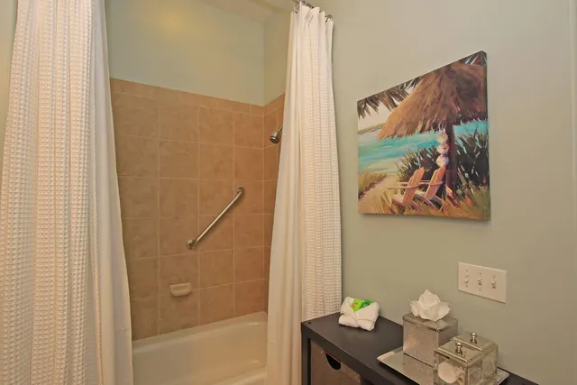 a bathroom with a shower curtain and a sink