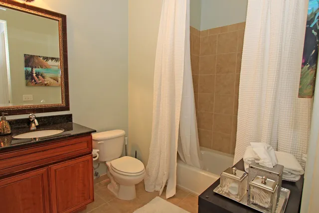 a bathroom with a toilet a sink and a mirror