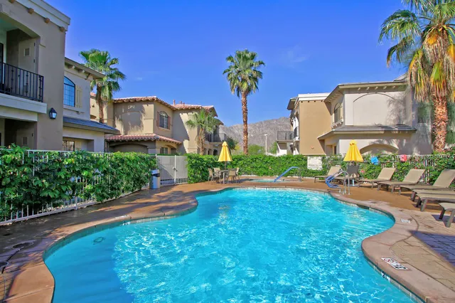 a front view of a house with swimming pool having outdoor seating