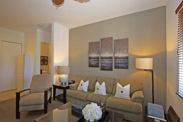 a living room with furniture and a potted plant