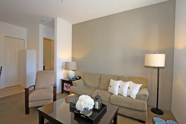 a living room with furniture and a lamp