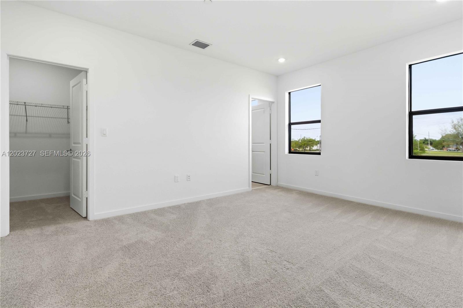 22348 Southwest 115th Court, Unit 22348 Miami, FL 33170 - Photo 19 of 37 an empty room with windows and closet