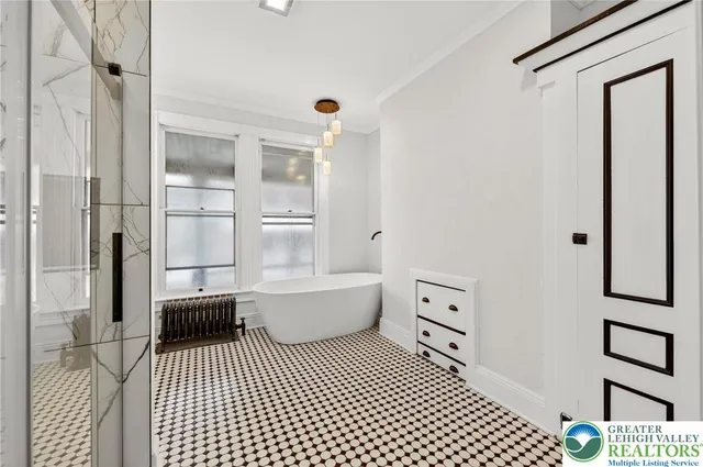 a bedroom with furniture and a window