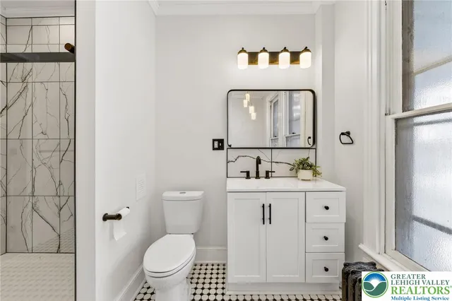 a room with white cabinets and wooden floor