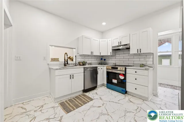 a spacious bedroom with a bed and a window