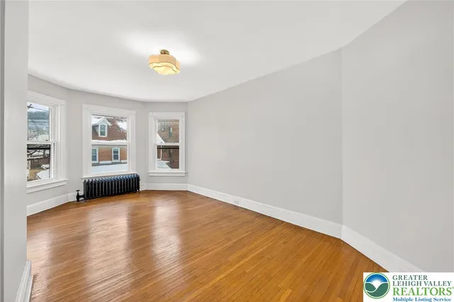 a bathroom with a toilet a sink a mirror and vanity