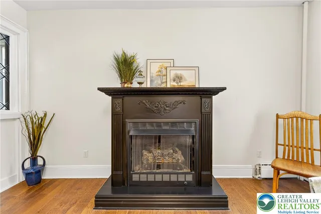a view of an empty room with window and fire place