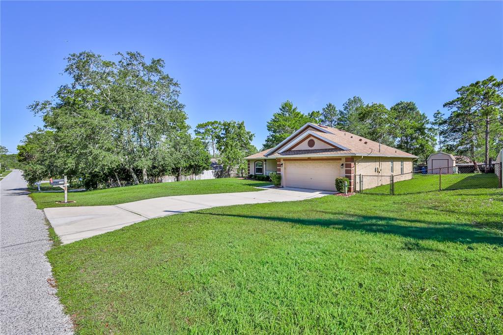 11213 Flock Avenue Weeki Wachee, FL 34613 - Photo 3 of 46 a front view of house with yard and green space